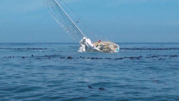 A partially submerged Clipper yacht
