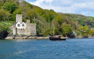 A motor cruiser making its way along the Devon coastline