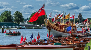 A red ensign flies from the stern of a boat at the Thames Traditional Boat Festival at Henley