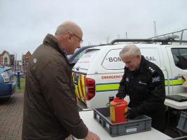 A boater handing over out of date flares