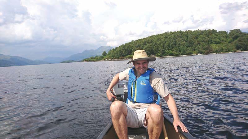 Running the outboard on a Canadian canoe during a 10km trip on Loch Lomond