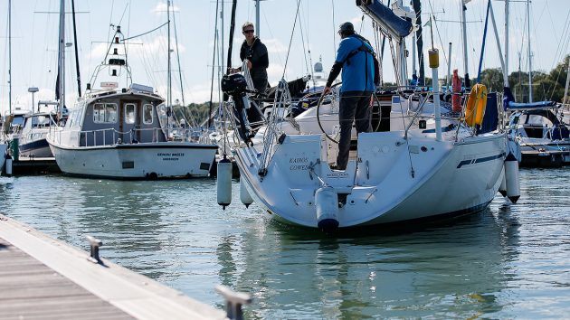 A yacht about to moor alongside a pontoon