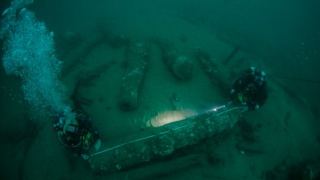 Lincoln Barnwell on the left and Julian Barnwell on the right measuring the wreck's cannon