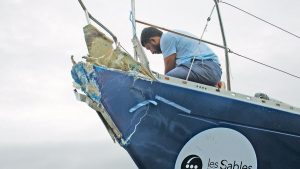 Abhilash Tomy looking at the damage to the bow of his Rustler 36