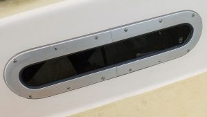 Some marine windows are sealed with a gasket tape that is compressed between the window and hull surface, while others, like this one from a Sadler 32, use a mastic sealant