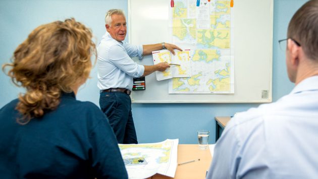 People in a classroom learning RYA Day Skipper Theory
