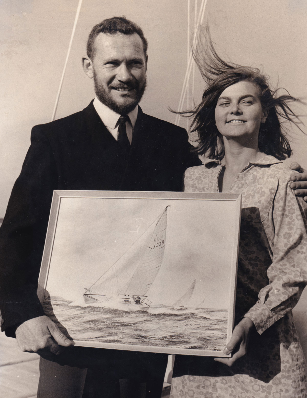 robin Knox johnston and nicoletter milnes walker holding a picture of a boat