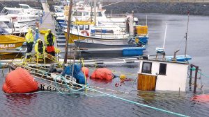 a boat salvage operation in a marina