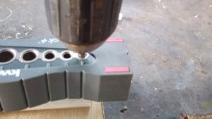 a person using a drill with a KWB DrillBlock handheld drilling jig