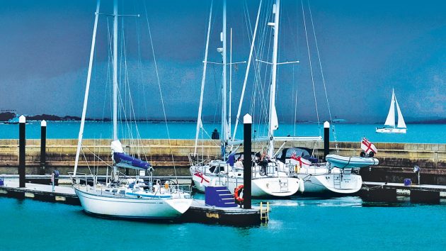 Boats in a marina underneath a dark sky