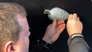 A man replacing an anode on a boat