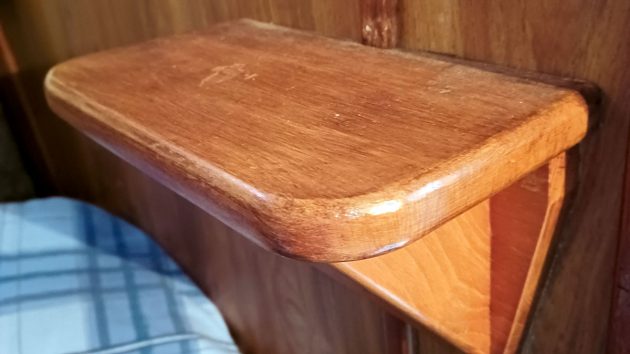 A shelf which is also a boat step on a yacht