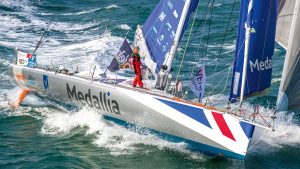 A woman on a large yacht racing solo