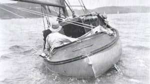 A man sailing in a boat alone