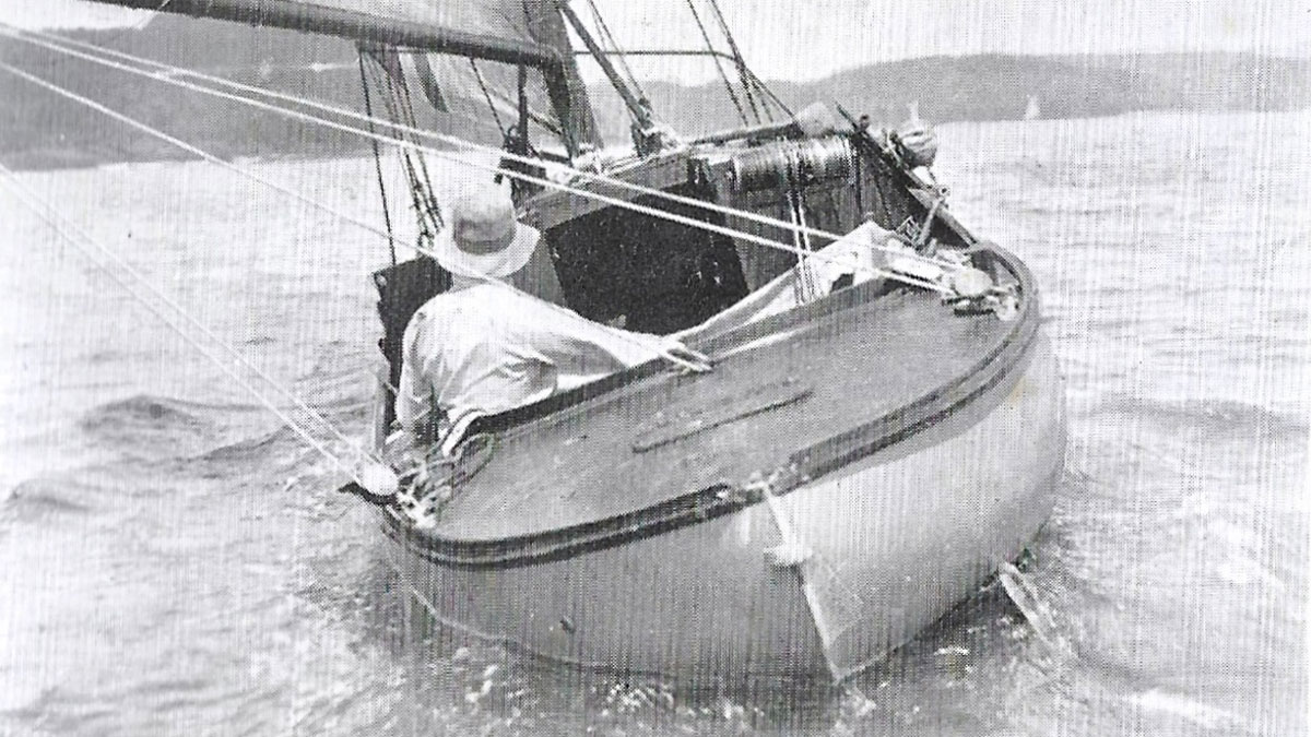 A man sailing in a boat alone