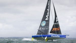 the IMOCA 60 yacht owned by Pip Hare foiling in the Solent