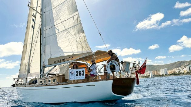 Aft view of a boat with a white hull and white sails