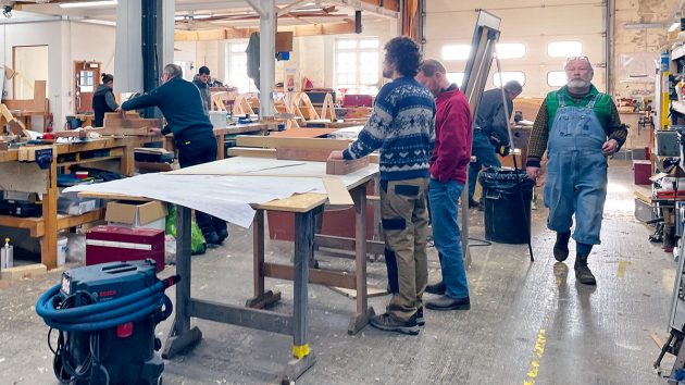 Students on a course to learn how to become a boat builder