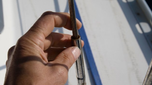 A person checking the rigging on a boat