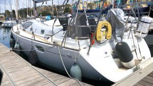 A yacht with a white hull moored alongside a pontoon