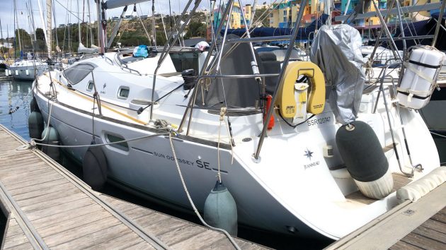 A yacht with a white hull moored alongside a pontoon
