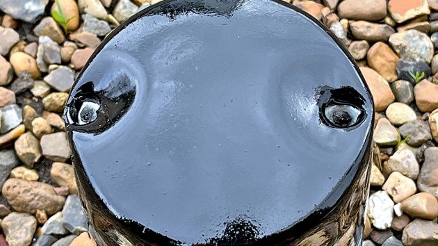 An old oil filter with punched holes