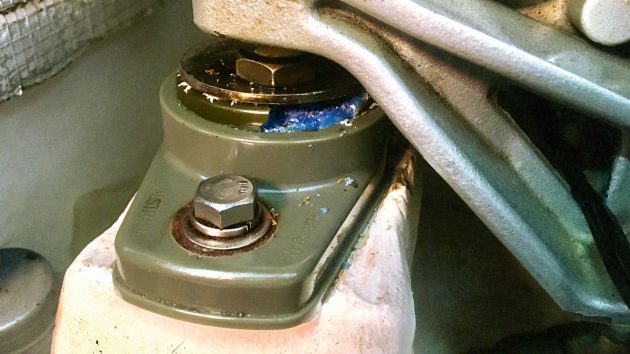 A degraded blue engine mount on a boat