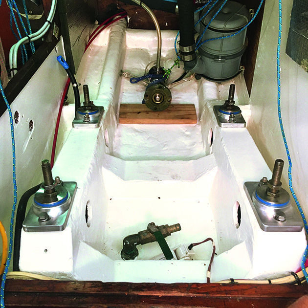 A painted engine bay on a boat with engine mount replacements