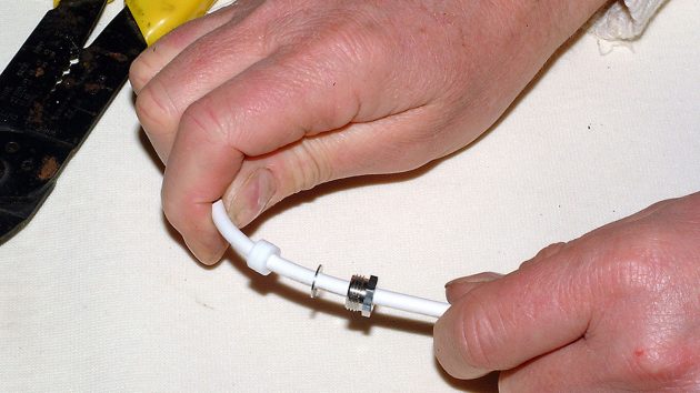 A washer being slipped onto a cable