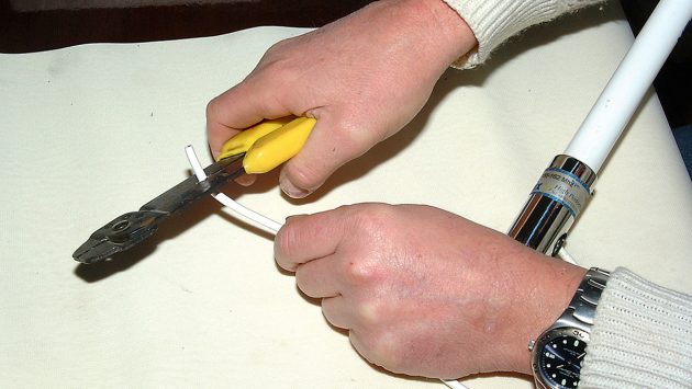 Carefully cut the outer insulation without damaging the braid. Ideally, use a wire stripper tool, although a craft knife used carefully works equally well.