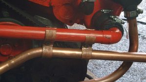 A copper clamp on a boat engine