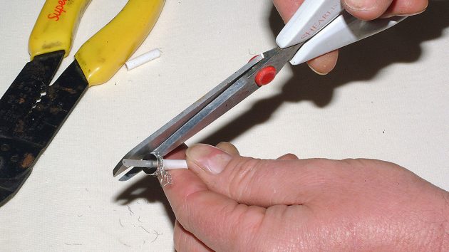 Using a pair of scissors, trim the braid until it is flush with the outside edge of the insert.