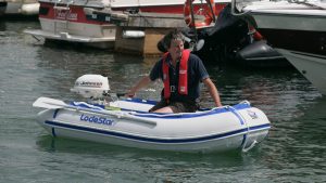 A man wearing a lifejacket in a dinghy