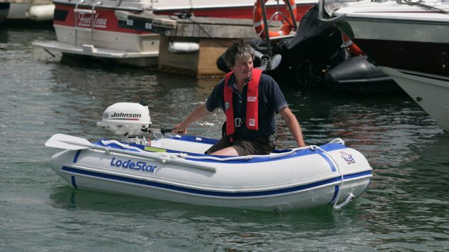 A man wearing a lifejacket in a dinghy