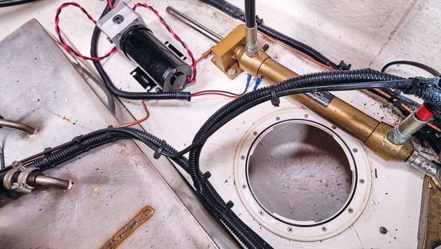 a pump being installed in a locker on a boat