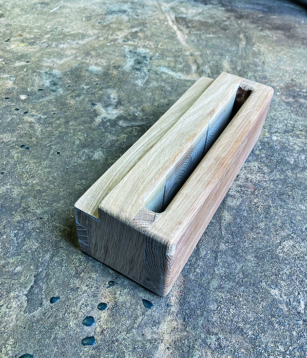 A mounting bracket for a wooden headboard for a boat