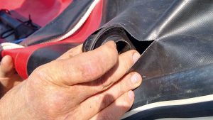 Inflatable boat valve replacement - a man putting in a new valve