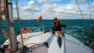 A woman on a boat shorthanded sailing