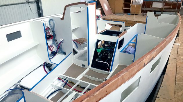 A hull of a plywood boat being fitted out