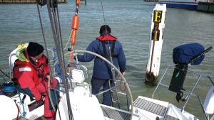 A man reversing a yacht to a pile mooring