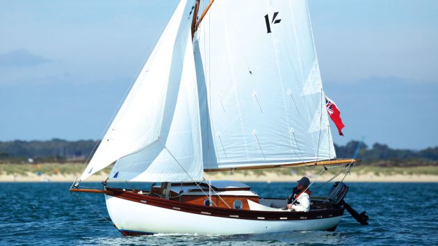 The Shilling boat with a white hull and white sails