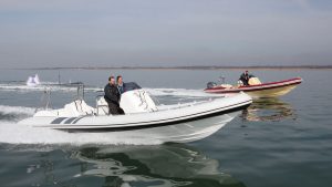 two couples cruising in powerboats at sea