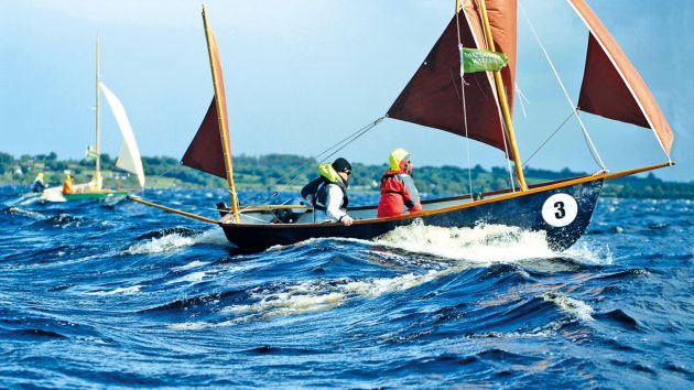 Two people in a boat sailing in waves