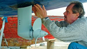 A man putting a new fairing gaiter back in place