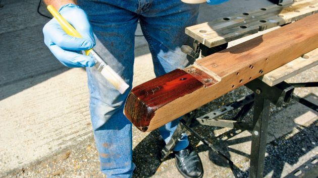 A person varnishing boat woods