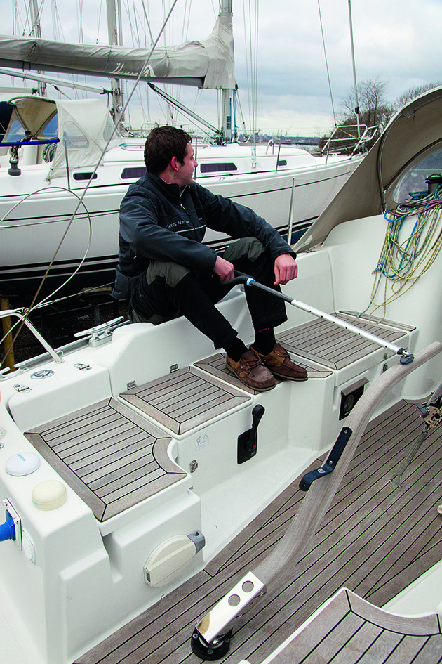 A man holding a tiller of a boat