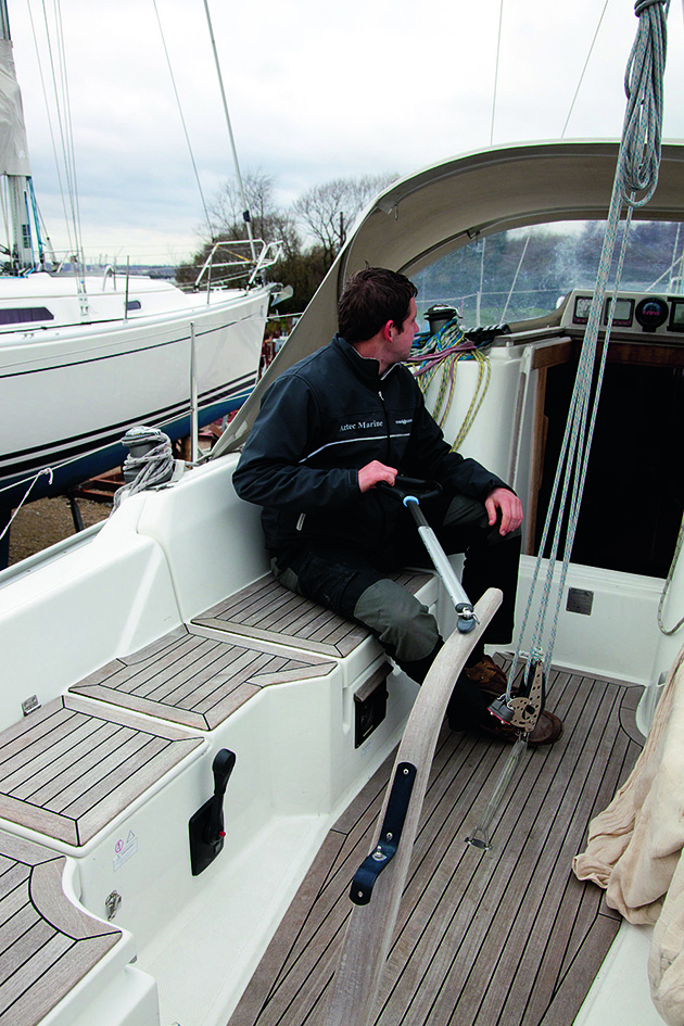 A man holding a tiller on a boat