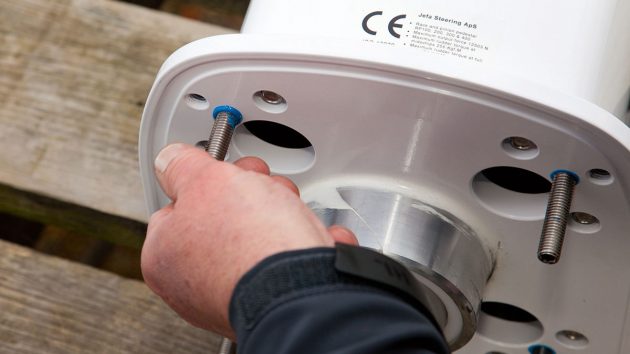 Studs being screwed into a pedestal as part of tiller to wheel conversion on a boat