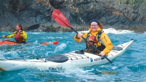 Katie paddles Toby's sea kayak in Pembrokeshire, Lundy region