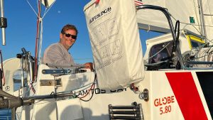 All smiles! 51-year-old Jack Johnson crossed the finish line and claims the Globe 5.80 Transat 2023 crown. Credit: Lutz Kohne / Class Globe 5.80